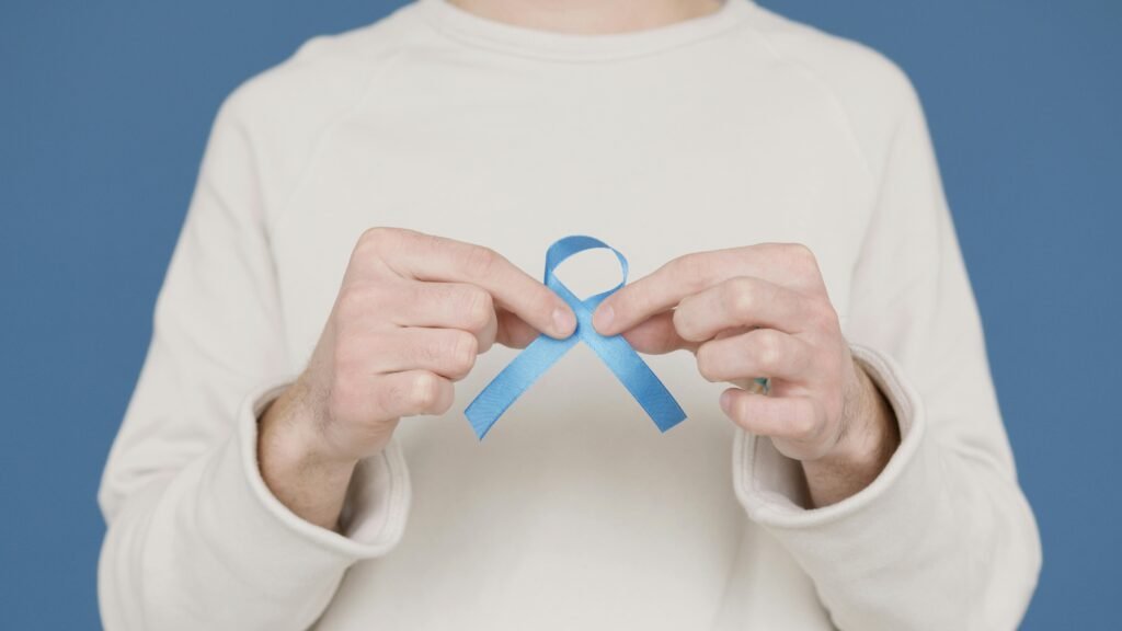 A person holding a blue awareness ribbon symbolizing support for various causes.